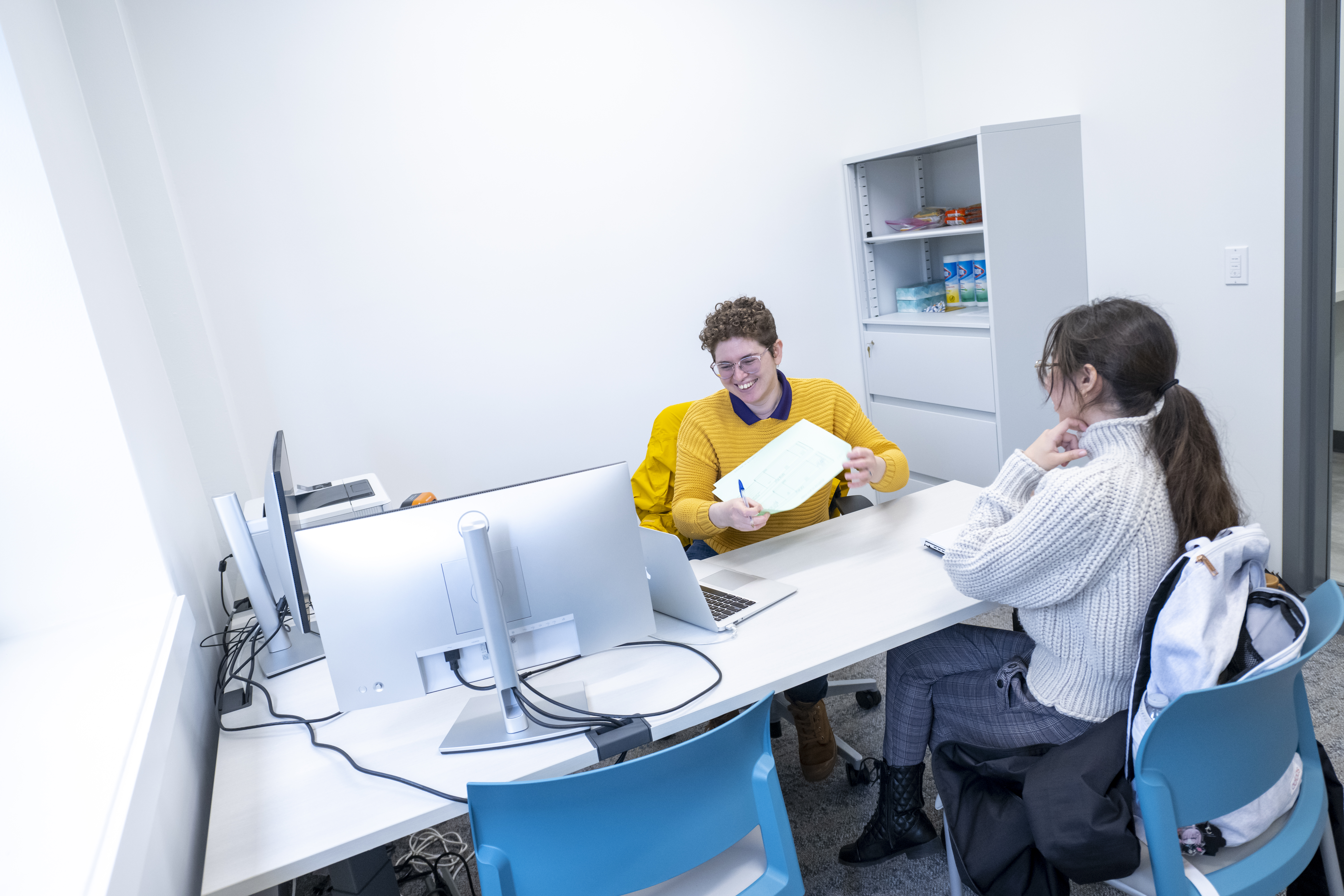 Someone providing another person a paper during counseling session