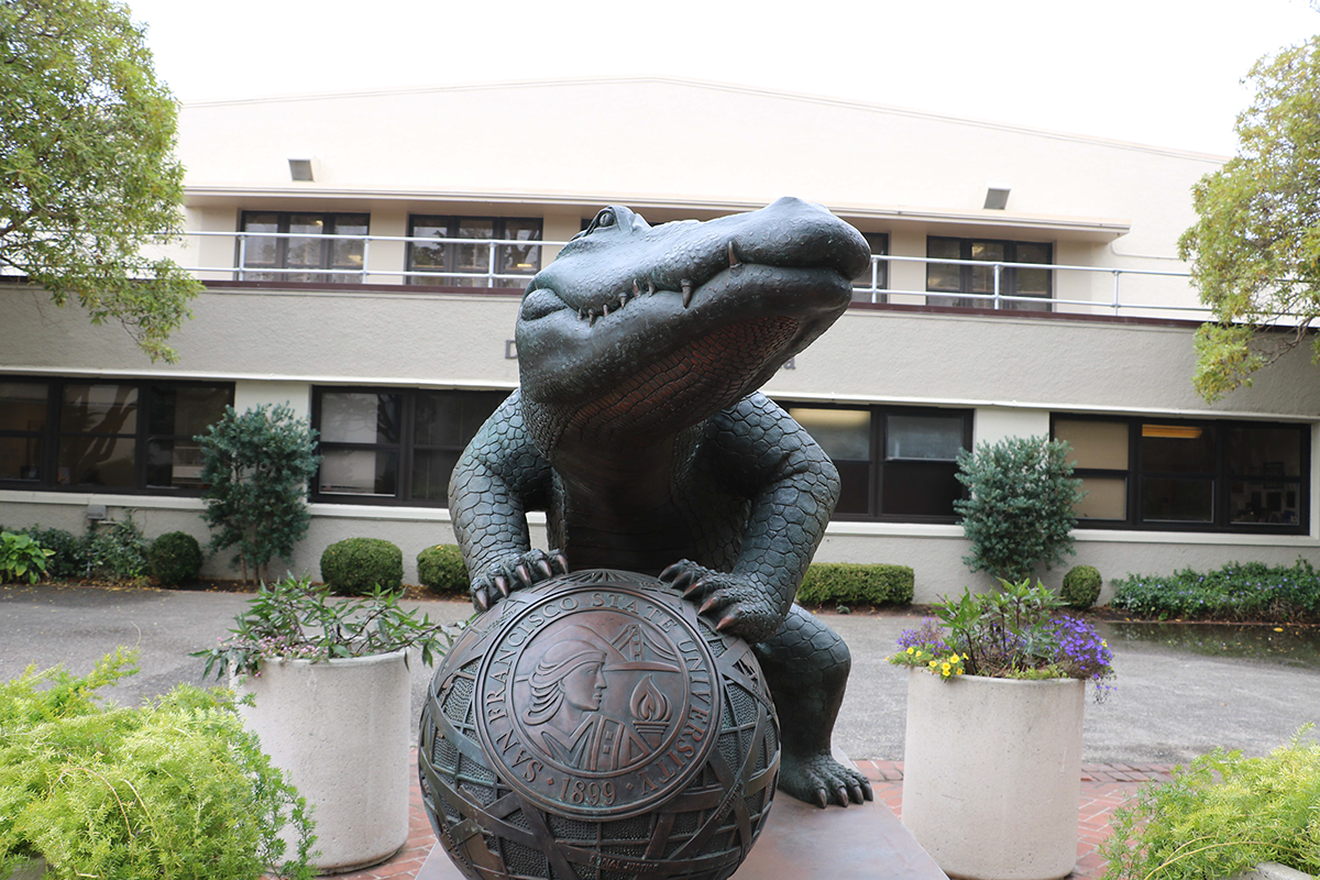 gator holding basketball