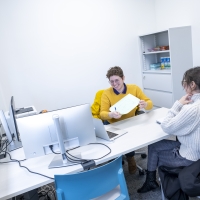 Someone providing another person a paper during counseling session